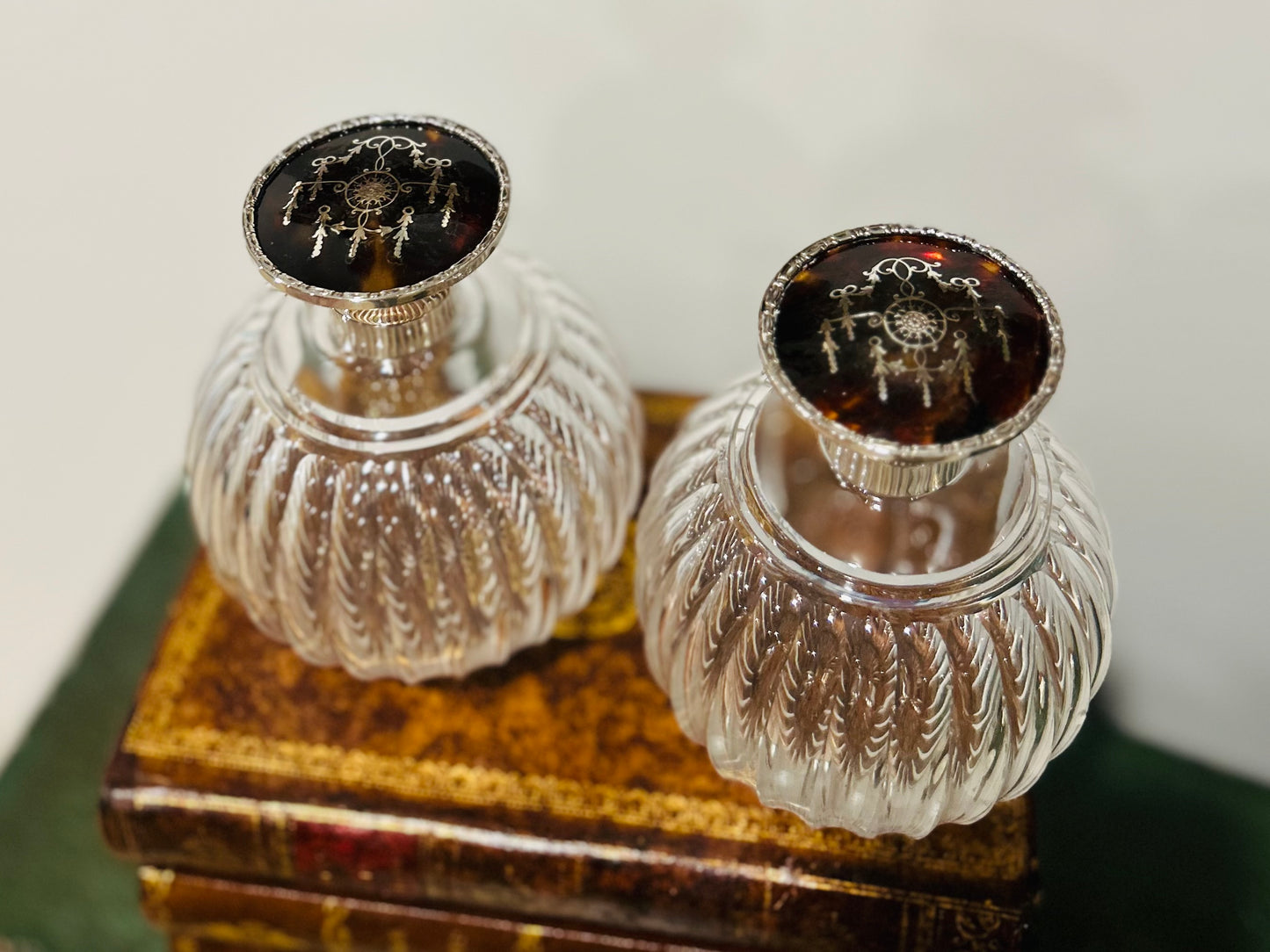 Pair of antique perfume bottles with tortoiseshell & sterling silver caps
