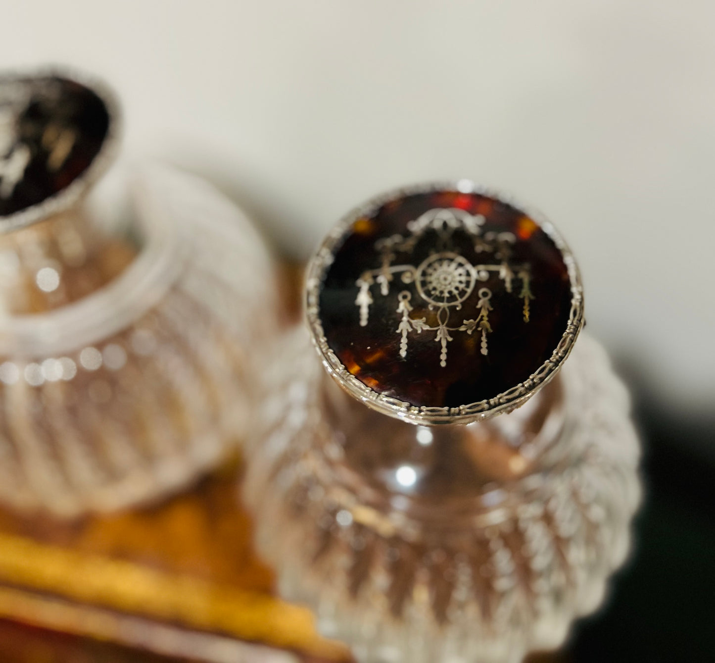 Pair of antique perfume bottles with tortoiseshell & sterling silver caps