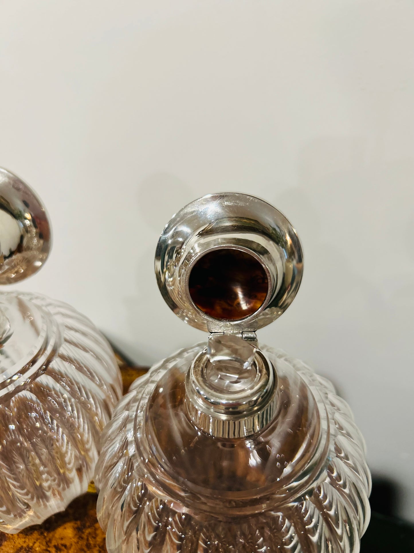 Pair of antique perfume bottles with tortoiseshell & sterling silver caps